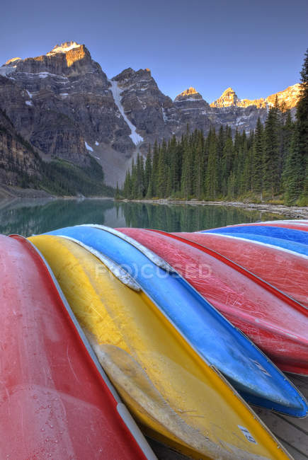 Frostige Kanus, die bei Sonnenaufgang am Moränensee im Tal der zehn Gipfel festmachen, Banff-Nationalpark, Alberta, Kanada. — Stockfoto