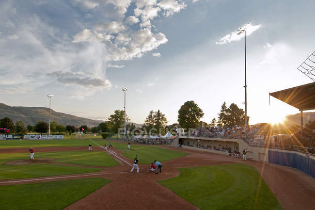 Baseball game being played at dusk in Kamloops, Thompson Okanagan region of British Columbia, Canada — Stock Photo
