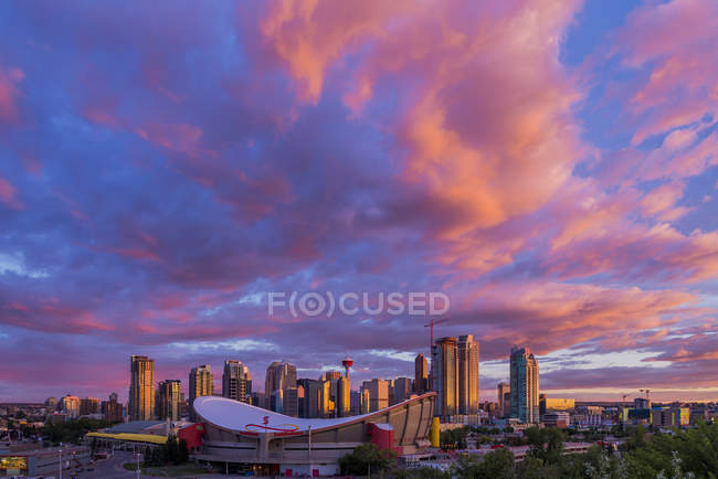 Saddledome arena y horizonte de la ciudad bajo el cielo dramático, Calgary, Alberta, Canadá - foto de stock