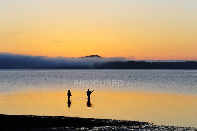 Due uomini salmone pesca al largo di Cherry Point spiaggia vicino a Cowichan Bay, BC. — Foto stock