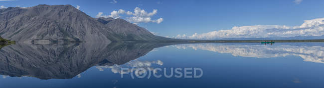 Canoa galleggiante sulla superficie speculare del lago Kathleen, Kluane National Park, Yukon . — Foto stock