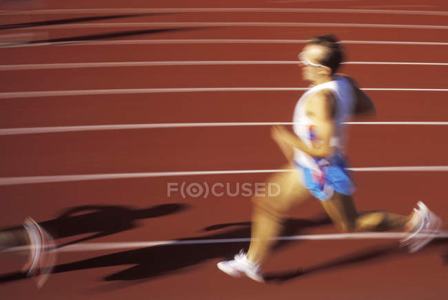 Male runner in race on track, British Columbia, Canada. — Stock Photo