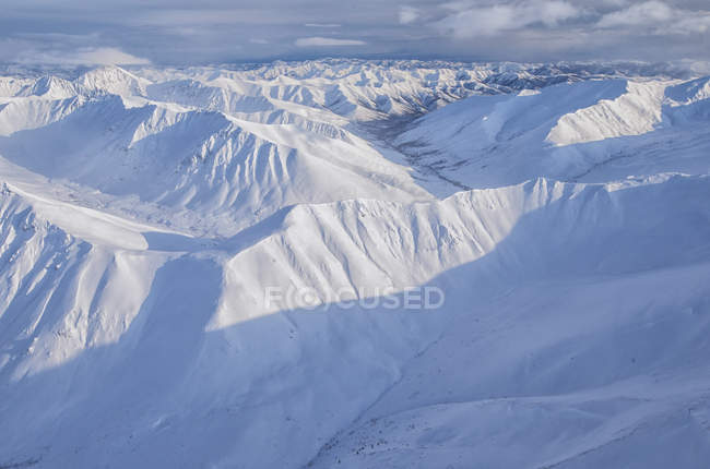 Aerial view of snow covered Ogilvie Mountains in Tombstone Territorial Park, Yukon, Canada. — Stock Photo