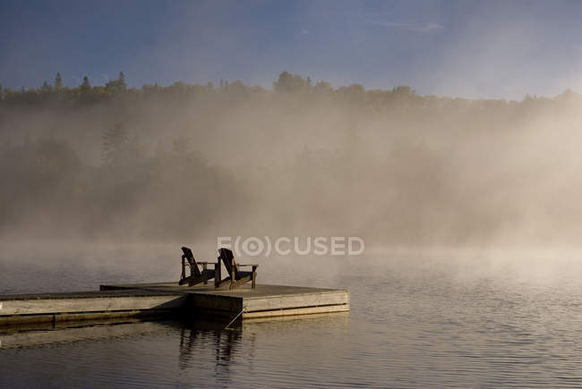 Autumn view of dock with Muskoka chairs, Oxtongue Lake, Ontario, Canada — Stock Photo
