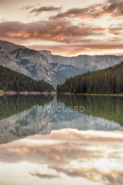 Sunrise over trees reflecting in water of Two Jack Lake, Banff National Park, Alberta, Canada — Stock Photo