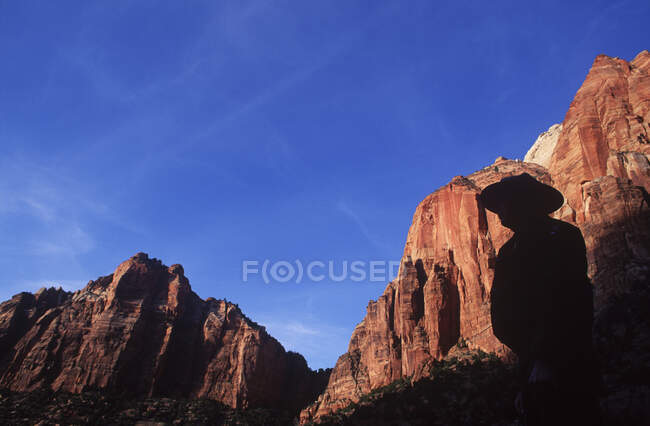USA, Utah, Zion National Park, cliffs along Virgin River as backdrop to ranger's sillouette — Stock Photo