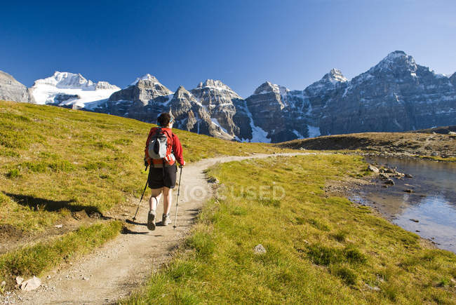 Mid adult female hiker walking in Larch Valley near Moraine Lake in Banff National Park, Alberta, Canada. — Stock Photo