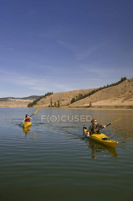 Two kayakers paddling in Trapp Lake, Kamloops, British Columbia, Canada — Stock Photo
