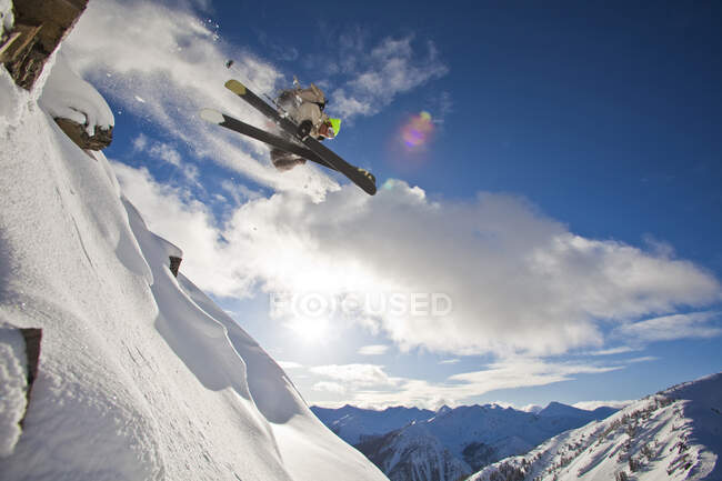 Male skier airing cliff in Kicking Horse Resort backcountry, Golden, British Columbia, Canada — Stock Photo