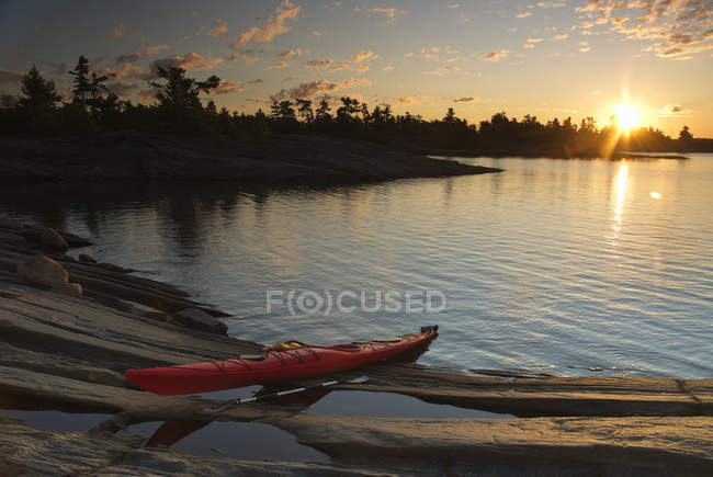 Kayak rojo en la orilla en Lake Huron, Geogian Bay, Canadian Shield, Ontario, Canadá - foto de stock