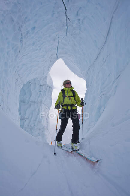 Mujer backcountry ski touring through glacier ice, Icefall Lodge, Golden, British Columbia, Canadá - foto de stock