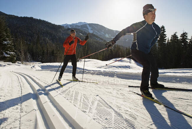 Cross country skiers skating trail on Chateau, Lost Lake Trails, Whistler, British Columbia, Canada — Stock Photo