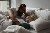 Couple romancing in bedroom at home — Stock Photo