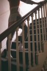 Sezione bassa di donna che cammina al piano di sopra a casa — Foto stock
