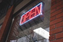 Close-up of shop with open sign with neon light — Stock Photo