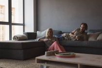 Пара, играющая в видеоигры в гостиной дома — стоковое фото