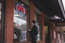Junger Mann blickt auf Schaufenster eines Geschäfts — Stockfoto