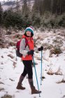 Thoughtful woman hiking in snowy region — Stock Photo