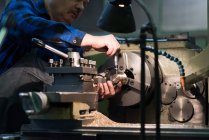 Technician in protective work wear repairing metal in industry — Stock Photo