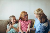 Mother and kids having fun in living room at home — Stock Photo