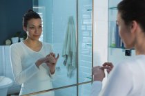 Woman standing in bathroom at home — Stock Photo