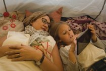 Mutter und Tochter nutzen digitales Tablet zu Hause im Zelt — Stockfoto