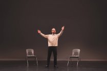 Male actor rehearsing on stage at theatre — Stock Photo