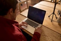 Attentive man using laptop at home — Stock Photo