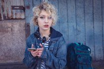 Portrait of woman using mobile phone in city — Stock Photo