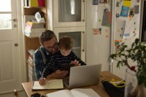 Батько з сином використовує цифровий планшет вдома — стокове фото