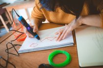 Woman using electric pen for drawing a sketch at home — Stock Photo