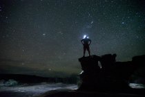 Male hiker standing with hands on hip in countryside at night — Stock Photo