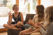 Siblings interacting with each other in living room at home — Stock Photo