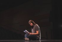 Female actress reading script on stage at theatre — Stock Photo