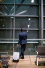 Rear view of businessman waiting at waiting area at airport — Stock Photo