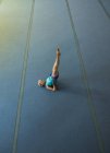 Sportswoman performing stretching exercise at fitness studio — Stock Photo