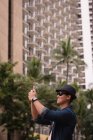 Uomo cliccando foto con cellulare in città — Foto stock