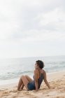 Женщина отдыхает на пляже в солнечный день — стоковое фото