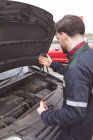 Mechaniker wartet Auto in Werkstatt — Stockfoto