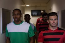 Front view of football players leaving the dressing room — Stock Photo