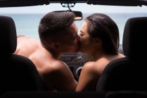 Romantic couple kissing each other in the car — Stock Photo