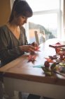 Hermosa mujer preparando una artesanía de papel en casa - foto de stock
