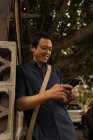 Улыбающийся бизнесмен с помощью мобильного телефона — стоковое фото