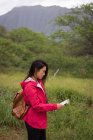 Beautiful woman looking at map in countryside — Stock Photo