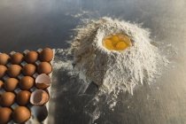 Primer plano de harina con yemas de huevo en panadería - foto de stock
