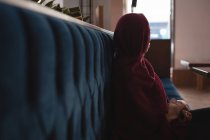 Thoughtful businesswoman in hijab relaxing at cafeteria — Stock Photo