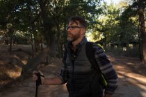 Вдумливий чоловічий пішохід, що стоїть на лісовій дорозі — стокове фото