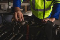 Engineer repairing aircraft engine in hangar — Stock Photo