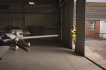 Airplane parked in aerospace hangar for maintenance — Stock Photo