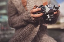 Женщина рассматривает фото с цифровой камерой в городе — стоковое фото